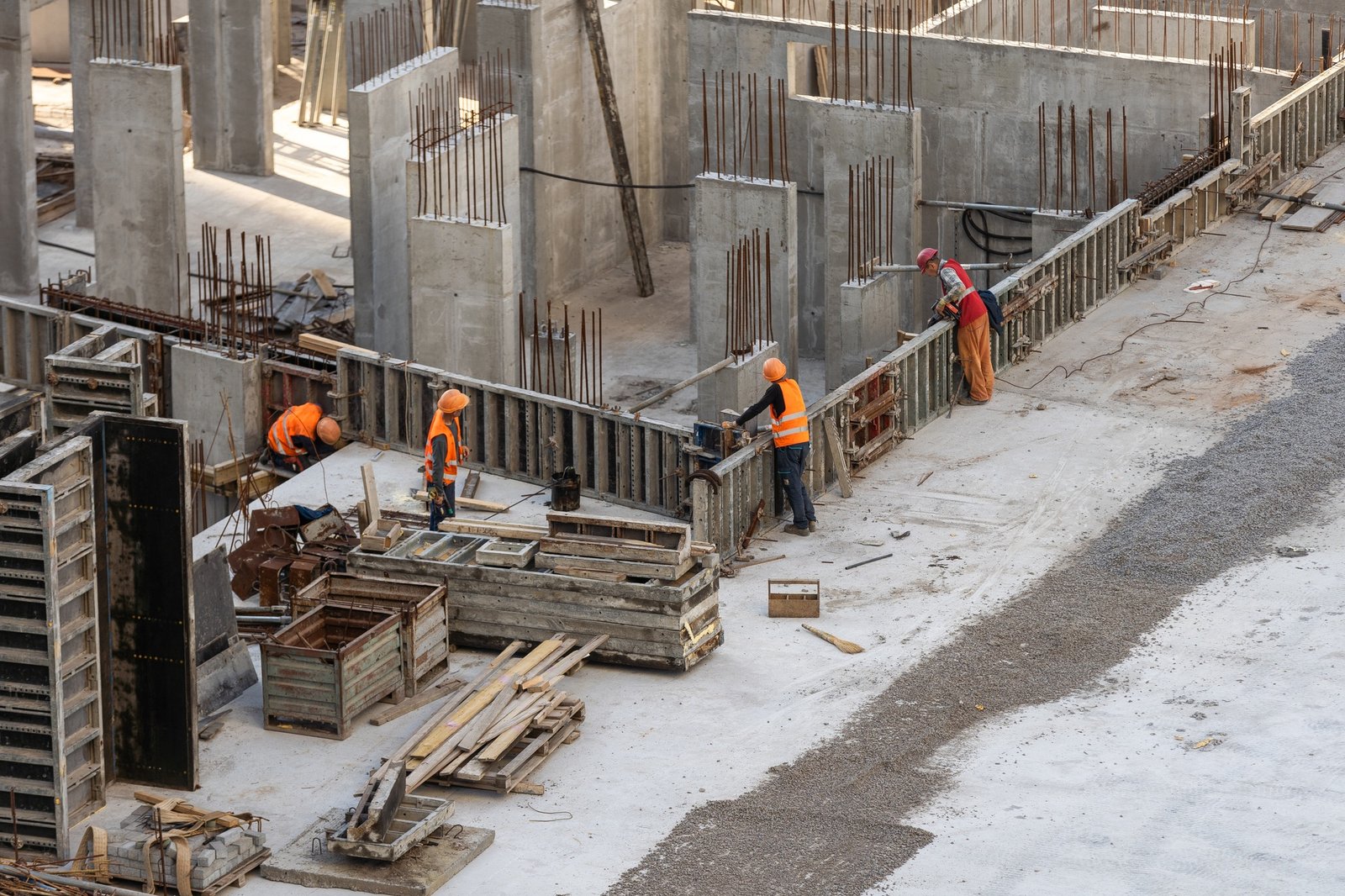 Construction worker Concrete pouring during commercial concreting floors of building in construction