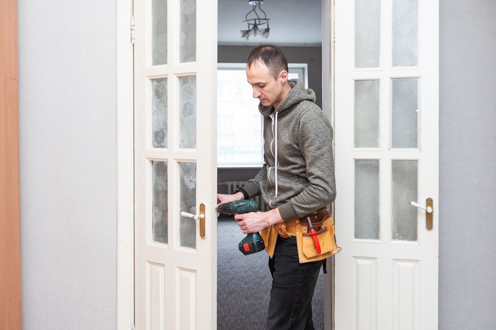 Locksmith, man and maintenance, handyman with home renovation and fixing, change door locks with